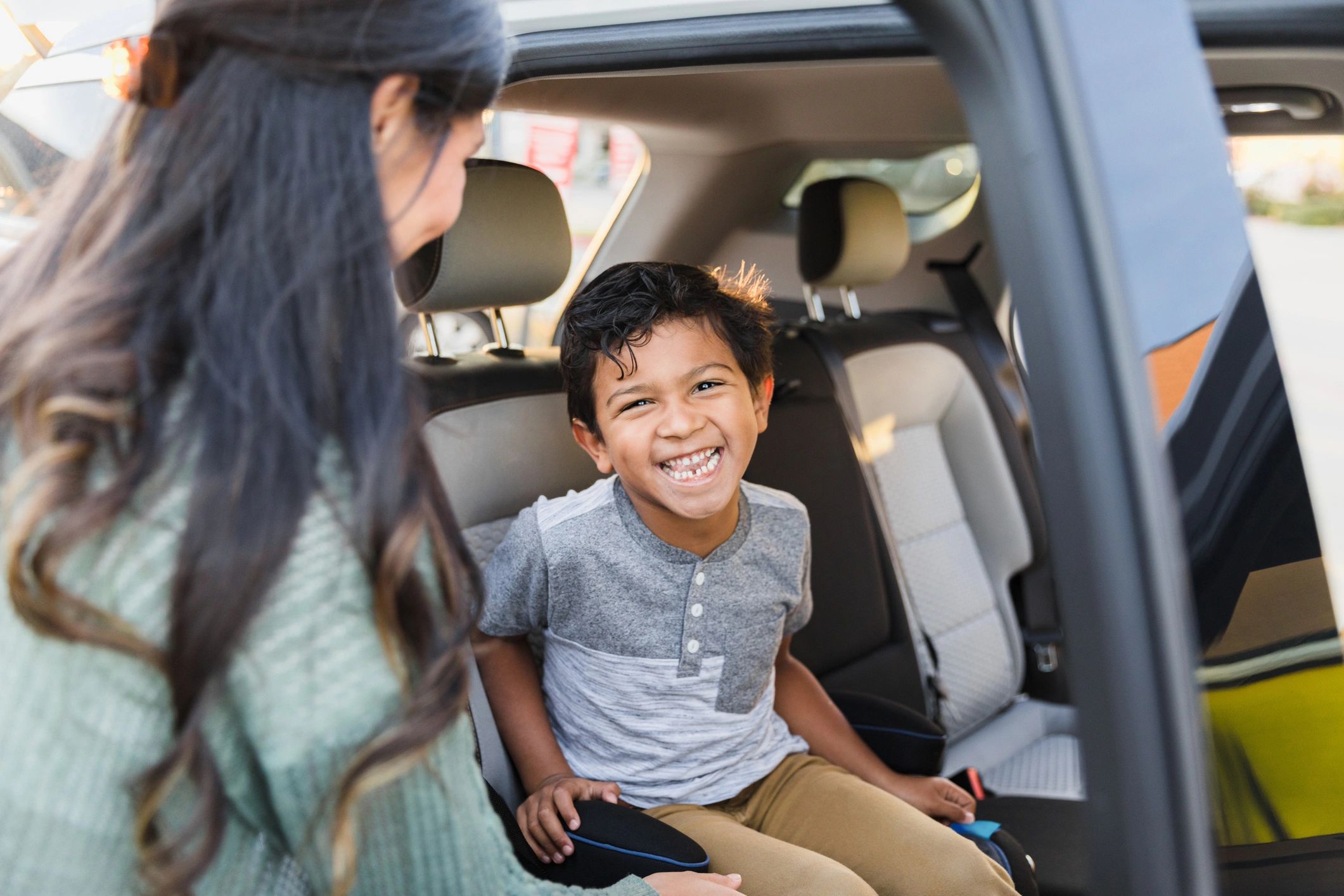 Child entering the back seat for a family ride
