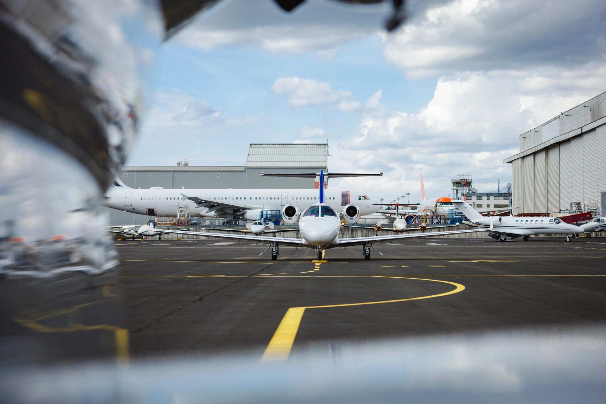 Private jets lined up on an airport tarmac