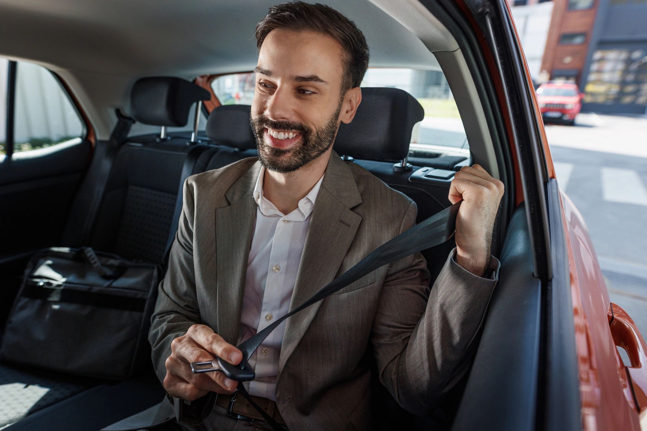 Passenger securing a seatbelt before travel