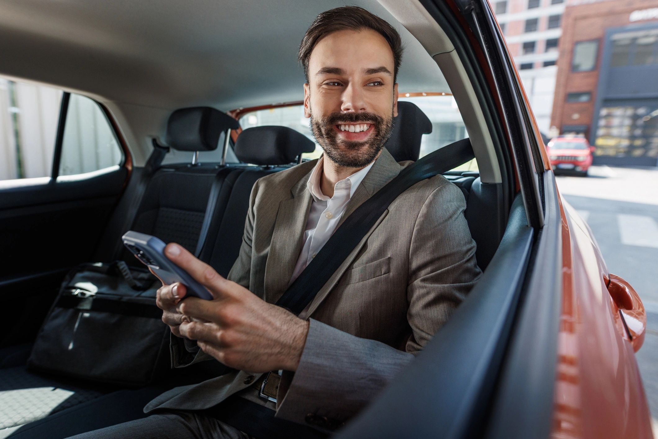 Corporate traveler in the back seat of a car