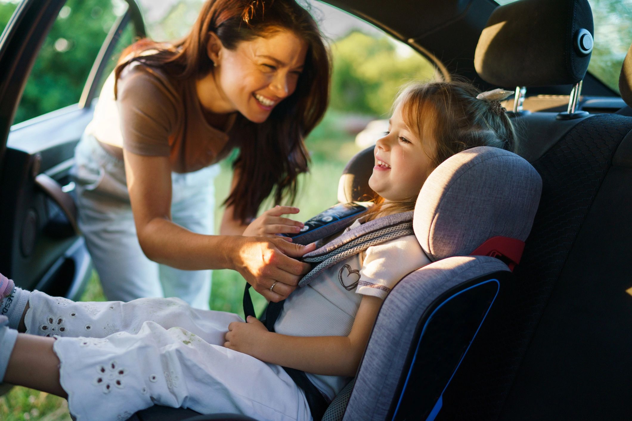 Child safely secured in a car seat before travel